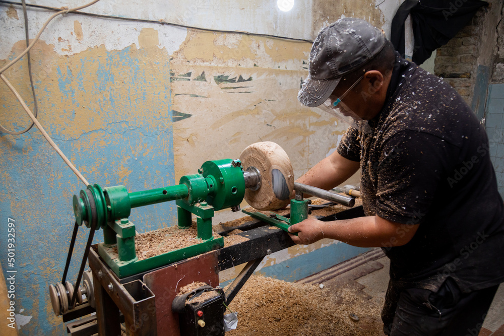 Carpenter preparing machine for turning wood on a lathe Carpenter preparing machine for turning wood on a lathe