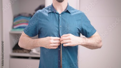Foto Headless male person button up elegant blue shirt with short sleeves