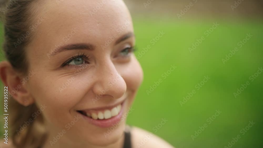 Close up of attractive woman smiling face looking ahead. Portrait of beautiful young woman with blue eyes. High quality 4k footage Close up of attractive woman smiling face looking ahead. Portrait of beautiful young woman with blue eyes. High quality 4k footage