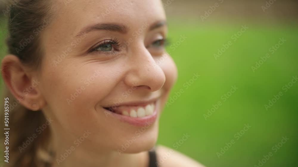 Close up of attractive woman smiling face looking ahead. Portrait of beautiful young woman with blue eyes. High quality 4k footage Close up of attractive woman smiling face looking ahead. Portrait of beautiful young woman with blue eyes. High quality 4k footage