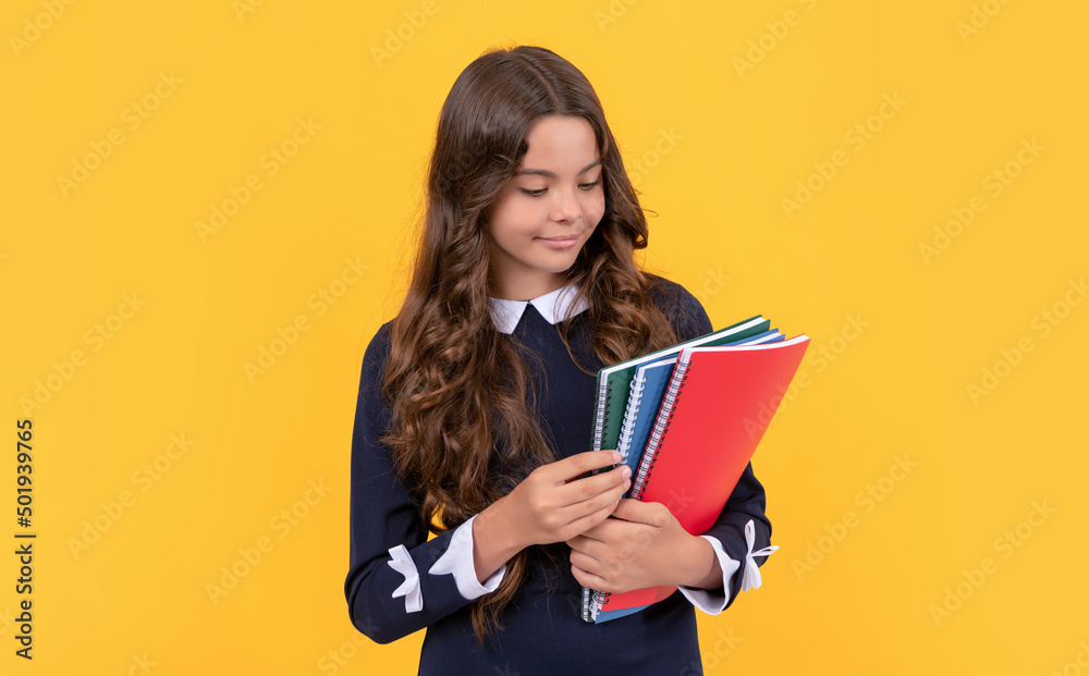 childhood. kid with smile on face going to do homework. teenager student hold copybooks. childhood. kid with smile on face going to do homework. teenager student hold copybooks.
