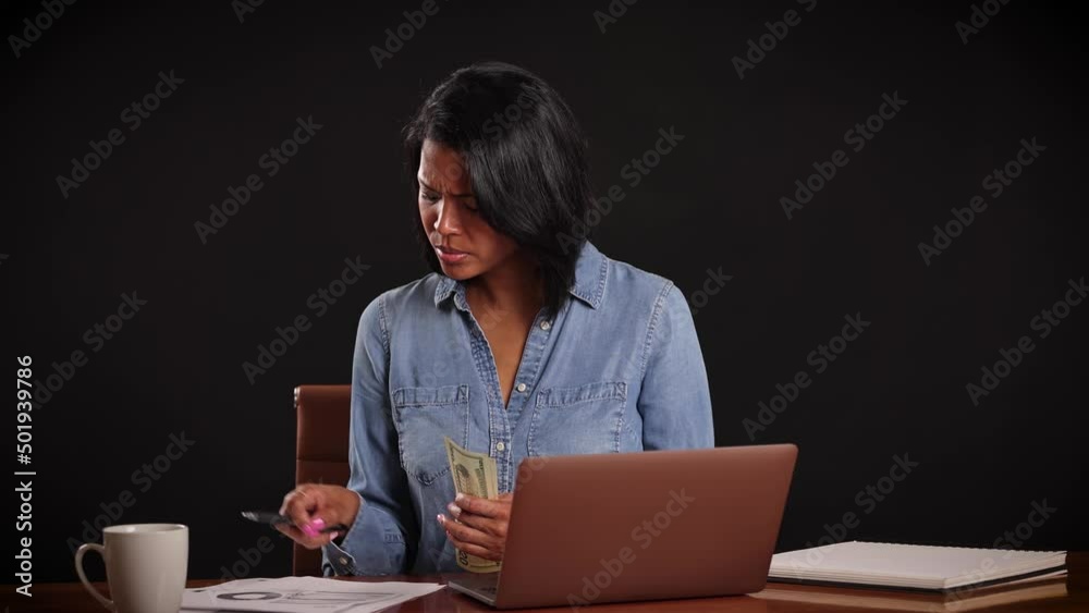 Mixed ethnicity (Asian-African) woman works on her laptop while working from home. Mixed ethnicity (Asian-African) woman works on her laptop while working from home.