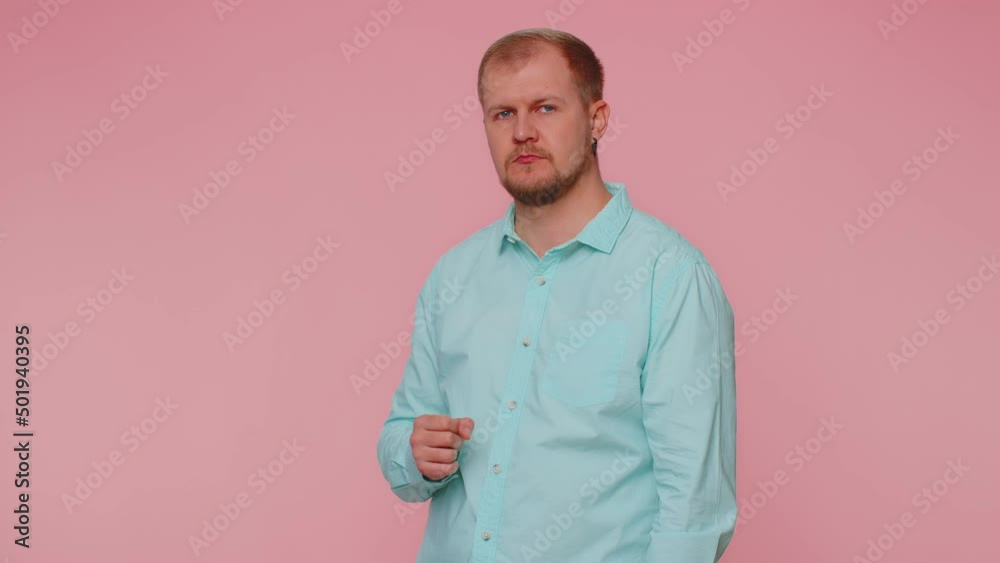 I am watching you. Man 30s in blue shirt pointing at his eyes and camera, show I am watching you gesture, spying on someone. Young adult blonde guy boy isolated alone on pink studio wall background I am watching you. Man 30s in blue shirt pointing at his eyes and camera, show I am watching you gesture, spying on someone. Young adult blonde guy boy isolated alone on pink studio wall background