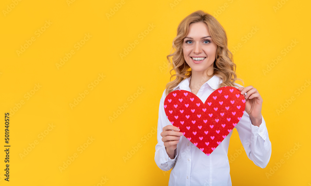 glad woman with red love heart on yellow background glad woman with red love heart on yellow background