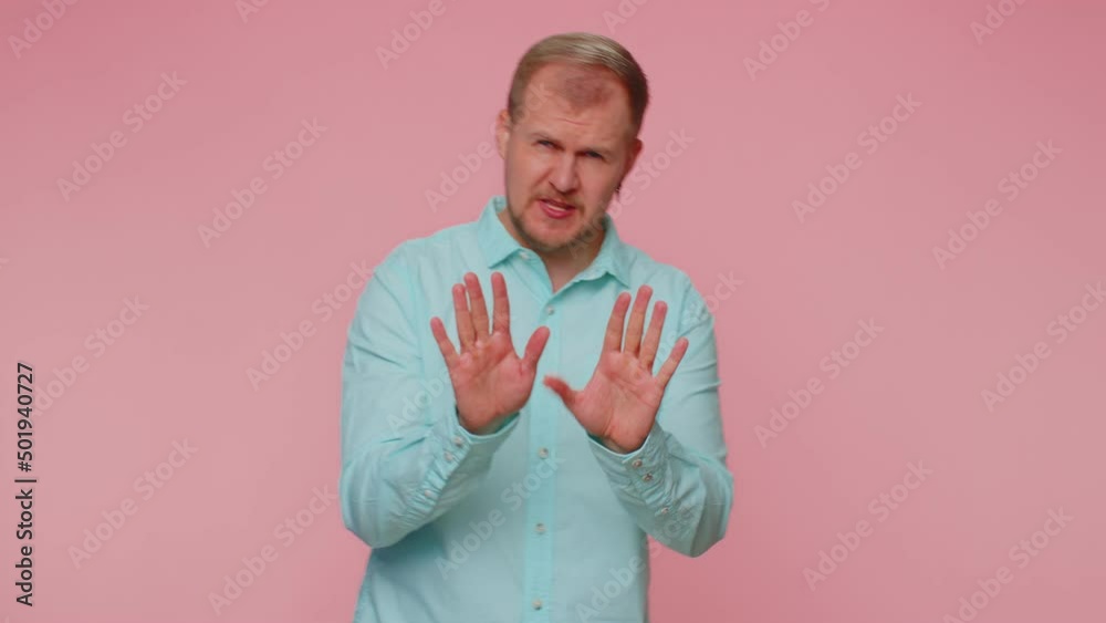 Hey you, be careful. Man warning with admonishing finger gesture, saying no, be careful, scolding and giving advice to avoid danger, disapproval sign. Young guy isolated on pink studio wall background Hey you, be careful. Man warning with admonishing finger gesture, saying no, be careful, scolding and giving advice to avoid danger, disapproval sign. Young guy isolated on pink studio wall background