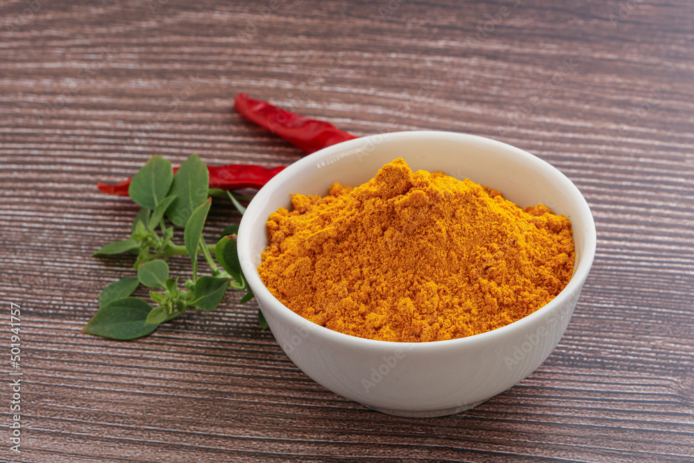 Yellow vibrant curcuma powder in the bowl Yellow vibrant curcuma powder in the bowl