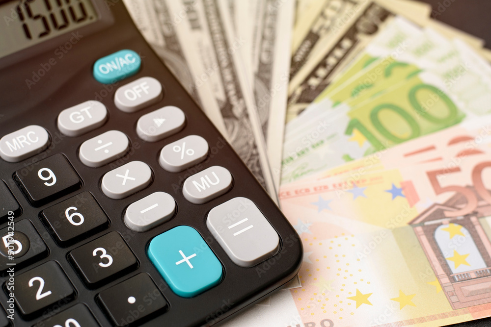 dollar and euro banknotes with calculator on black background dollar and euro banknotes with calculator on black background