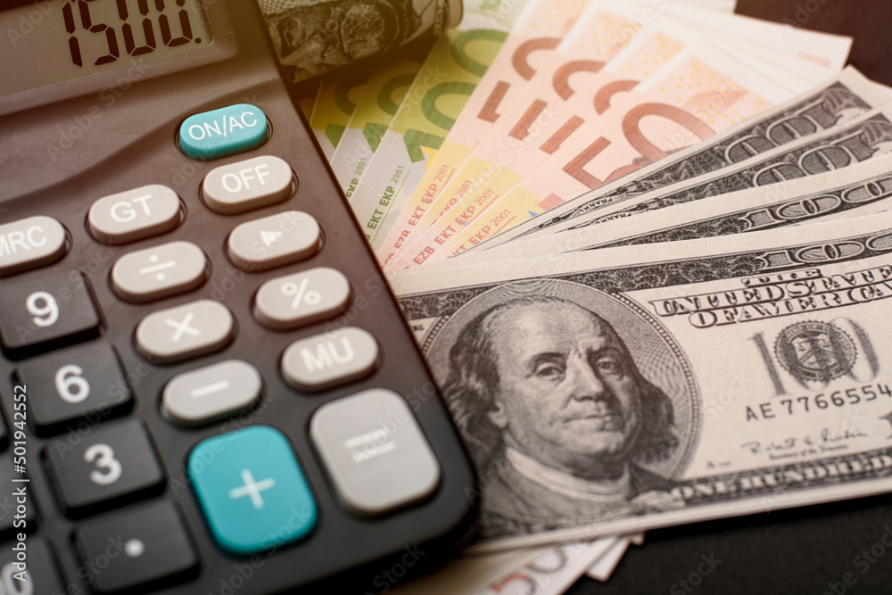 dollar and euro banknotes with calculator on black background dollar and euro banknotes with calculator on black background