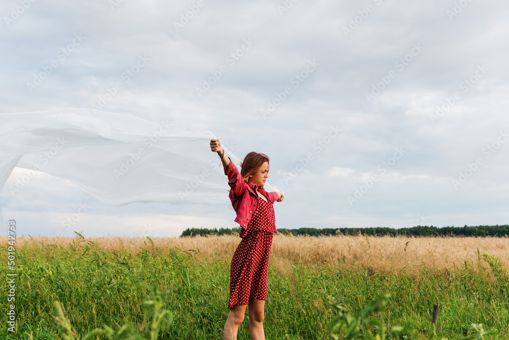 Image of a young girl on the background of a country landscape Image of a young girl on the background of a country landscape