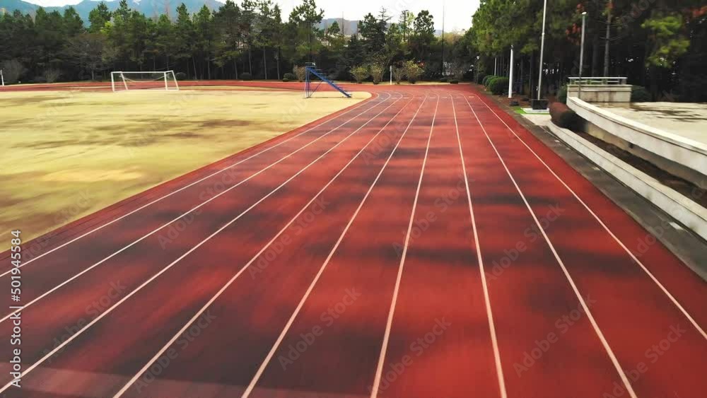Aerial footage of the drone flying over the empty running track