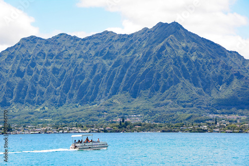 Pontoon boat in Kaneohe Bay with mountains in background on the windward side of Oahu, Hawaii near Kaneohe Marine Corps Base © Ryan Tishken