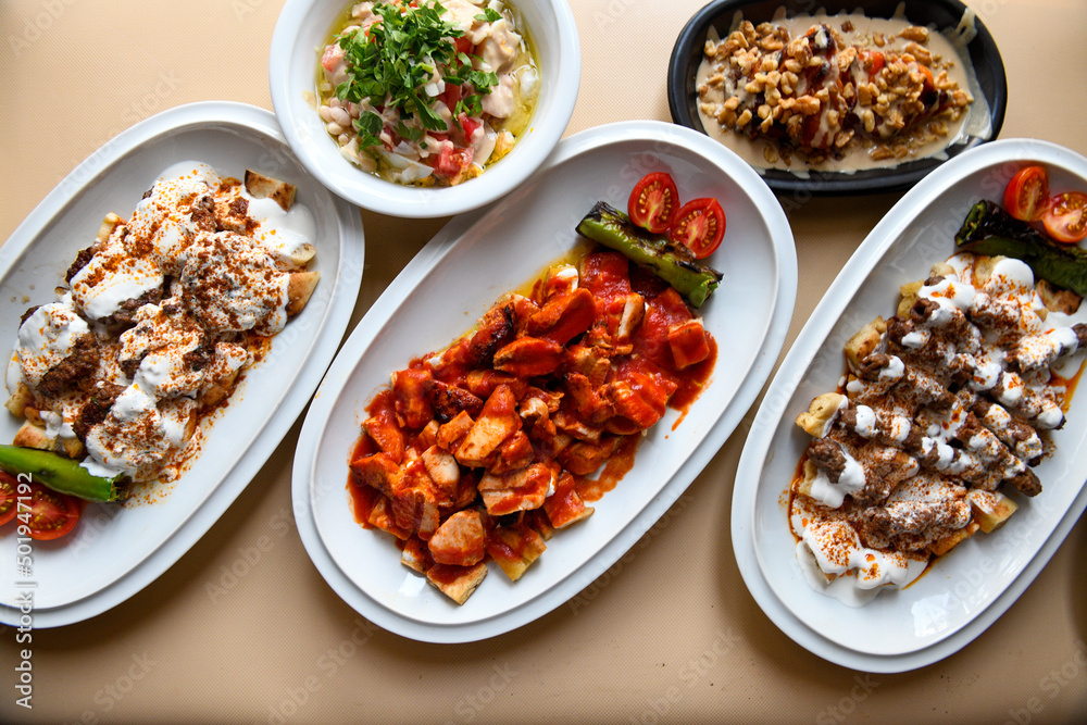 Table scene of assorted take out or delivery foods. Traditional Turkish cuisine. Various Turkish meal and appetizers. Top down view on a table. Table scene of assorted take out or delivery foods. Traditional Turkish cuisine. Various Turkish meal and appetizers. Top down view on a table.