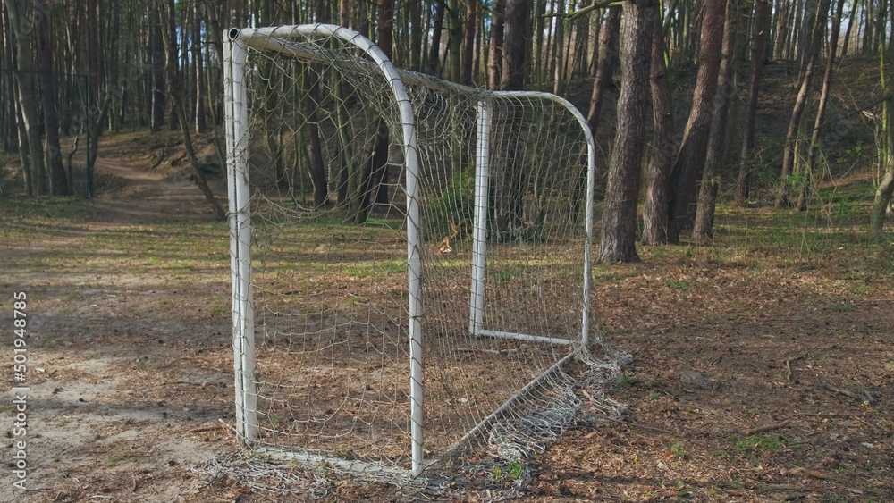 Neglected Abandoned Soccer Field Football Gate with Torn Entangled Net