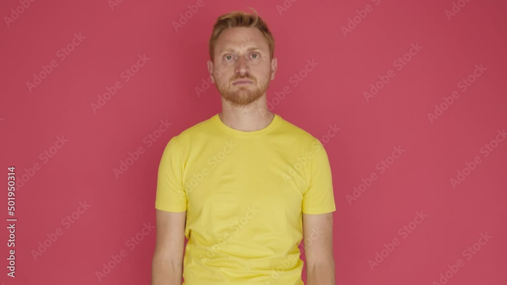 Redhead young man crossing arms and smiling at camera over isolated background. Happy male with crossed arms feeling confident. High quality 4k footage Redhead young man crossing arms and smiling at camera over isolated background. Happy male with crossed arms feeling confident. High quality 4k footage