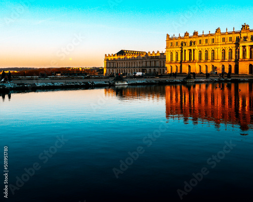 versailles castle in france at sunset with lake in frontersailles castle in france at sunset with lake in front