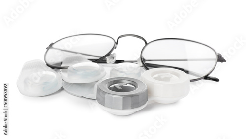 Packages with contact lenses, case and glasses on white background
