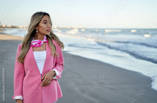 beautiful young girl walking on the beach