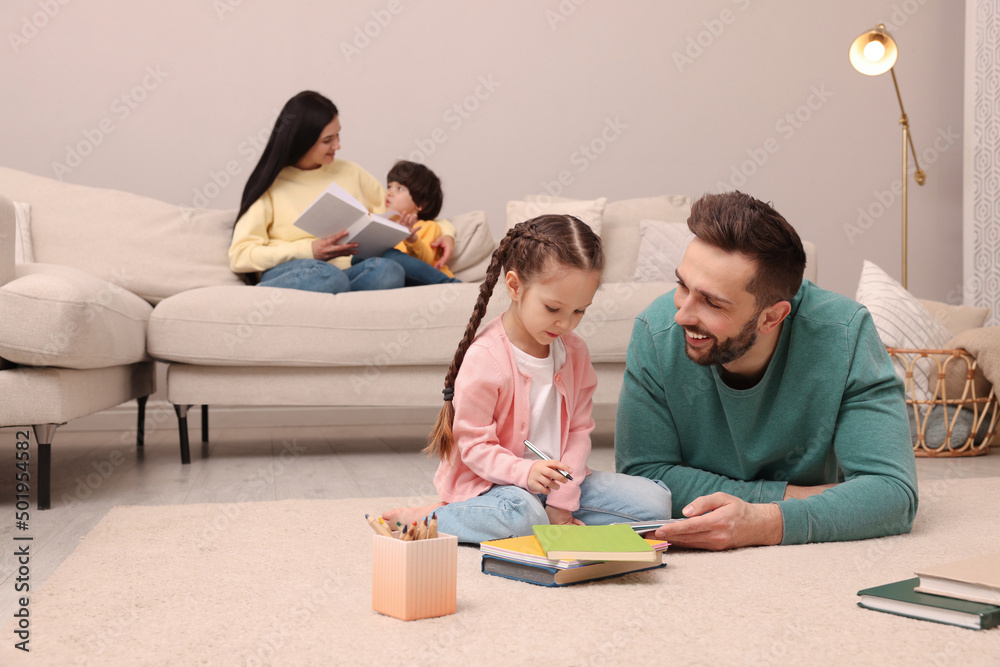 Happy family spending time together in living room Happy family spending time together in living room