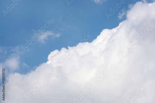 Fluffy white clouds on background of blue sky.