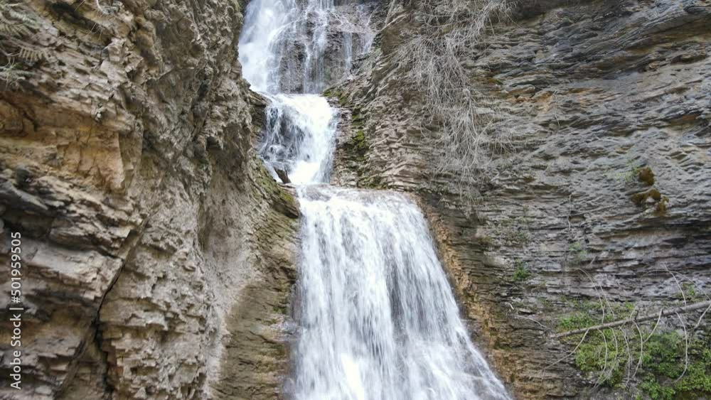 Margaret Falls flowing down a rocky mountain cliff in the scenic and popular Herald Provincial Park located in British Columbia, Canada. Low angle aerial shot Margaret Falls flowing down a rocky mountain cliff in the scenic and popular Herald Provincial Park located in British Columbia, Canada. Low angle aerial shot
