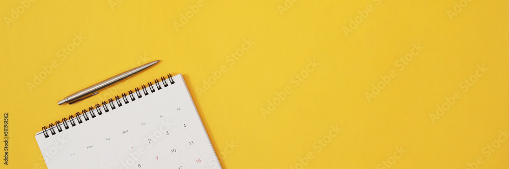 close up top view calendar schedule to make appointment meeting or manage timetable each day lay on yellow background for planning work and travel concept. close up top view calendar schedule to make appointment meeting or manage timetable each day lay on yellow background for planning work and travel concept.