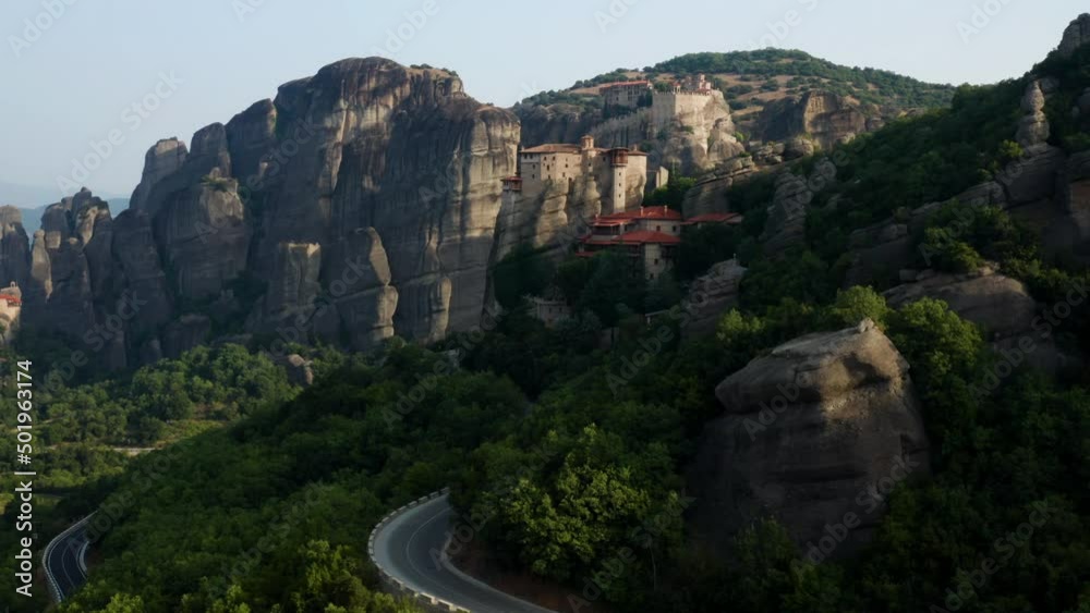Majestic Rock Formation And One Of Famous Monasteries Of Meteora In Greece - aerial shot Majestic Rock Formation And One Of Famous Monasteries Of Meteora In Greece - aerial shot