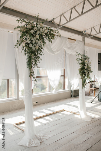 Wedding arch with fabric, eucalyptus, roses, eustoma. Wedding decoration for the bride and groom © Антон Романюк