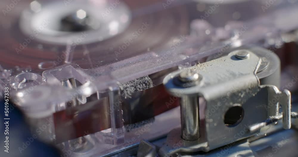 Close-Up Of Microcassette Recorder Tape Ribbon Running Through Cassette Close-Up Of Microcassette Recorder Tape Ribbon Running Through Cassette