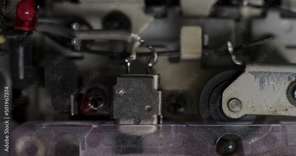 Close-Up Of Playhead And Pinch Roller Operating Inside Microcassette Recorder Close-Up Of Playhead And Pinch Roller Operating Inside Microcassette Recorder