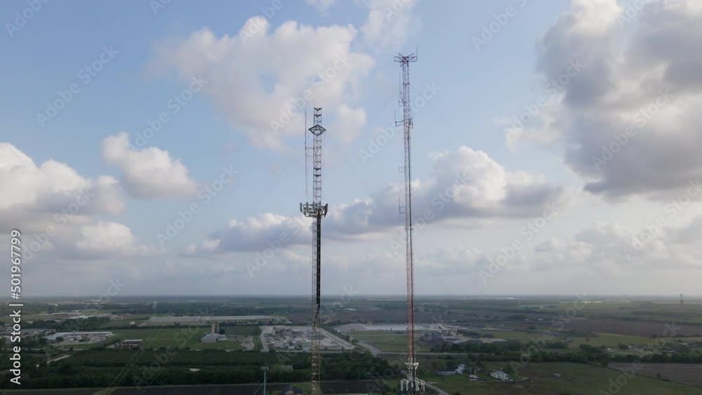 Aerial Shot Floating Away From Two Tall Cellular Towers In American Farmland Aerial Shot Floating Away From Two Tall Cellular Towers In American Farmland