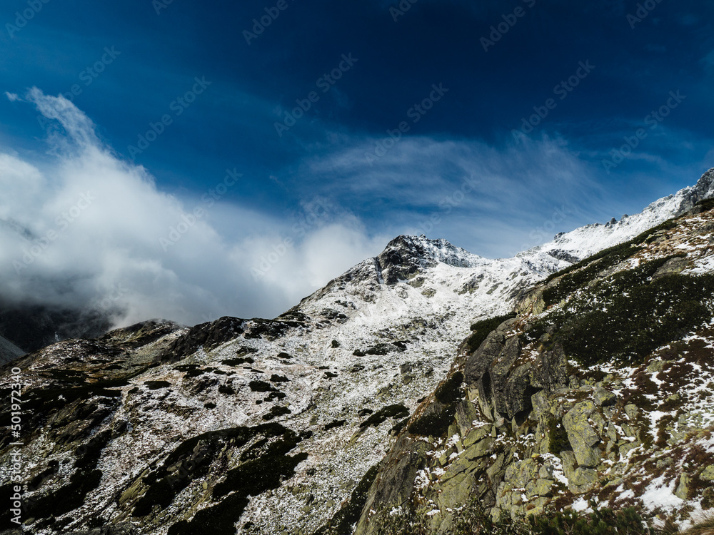 beautifull cloudy day in the mountains with snow ridge. snow caped mountain peak in the Slovak Tatras