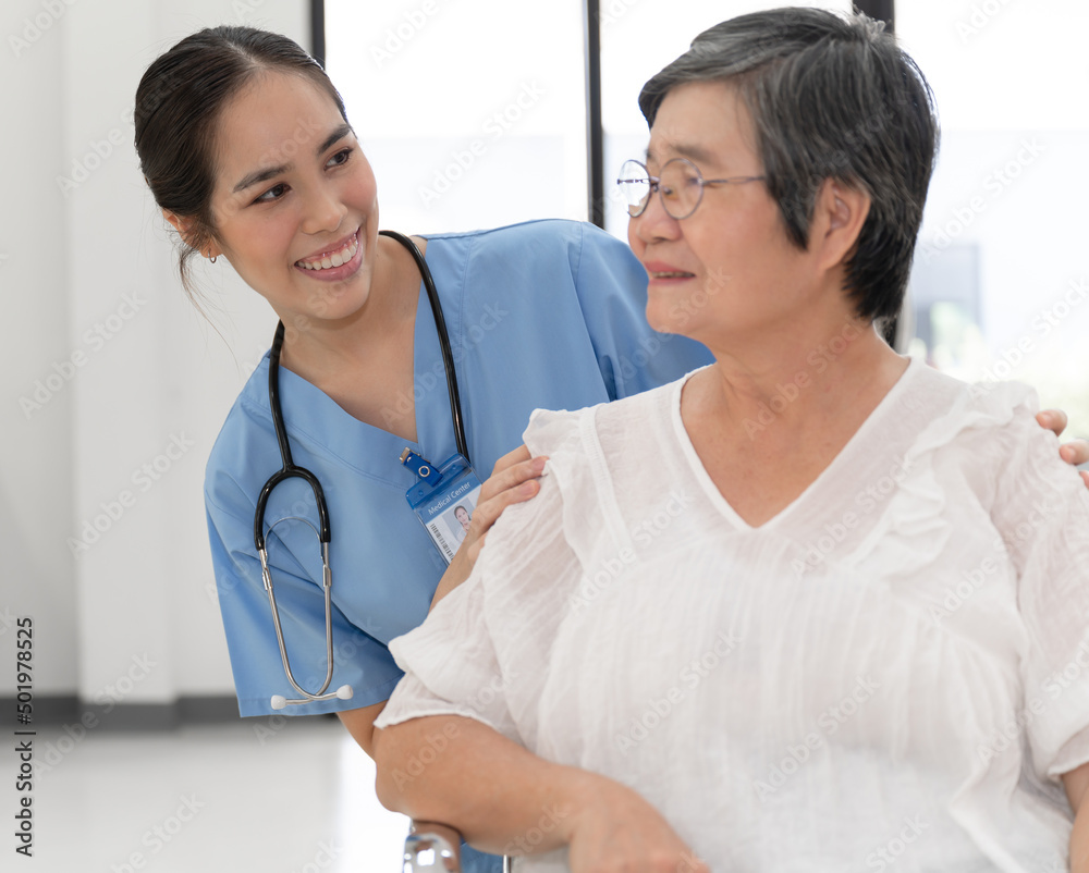 Happy doctor woman with senior woman patient at hospital 