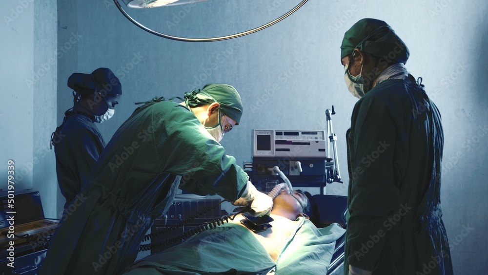 Defibrillation cardiac dysrhythmia, Surgical doctor team performing surgery patient on operating room in hospital, doctors use medical devices automated External Defibrillator to pump hearts patients Defibrillation cardiac dysrhythmia, Surgical doctor team performing surgery patient on operating room in hospital, doctors use medical devices automated External Defibrillator to pump hearts patients