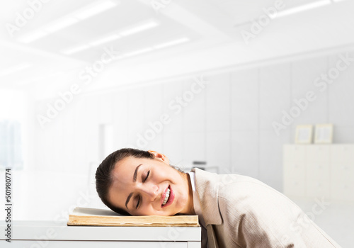 Exhausted business woman sleeping on desk