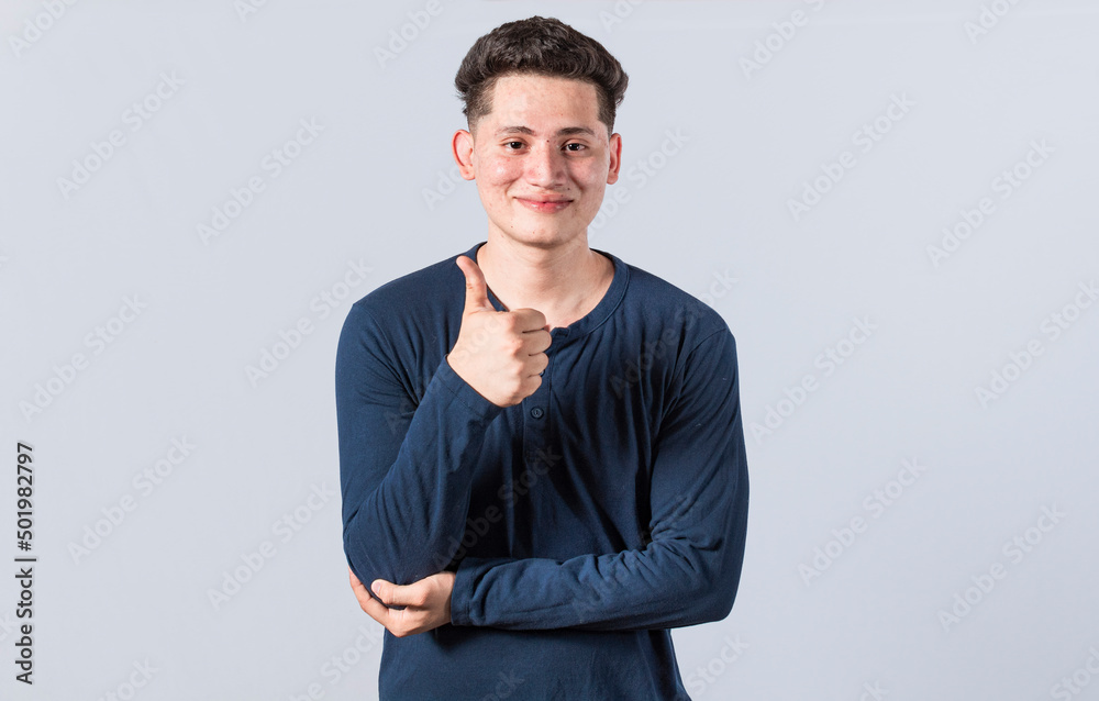 Smiling man showing ok gesture looking at camera, Man gesturing everything is ok, young man making ok gesture, expression of everything is fine. Smiling man showing ok gesture looking at camera, Man gesturing everything is ok, young man making ok gesture, expression of everything is fine.