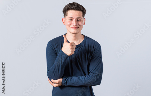Smiling man showing ok gesture looking at camera, Man gesturing everything is ok, young man making ok gesture, expression of everything is fine. © IHERPHOTO