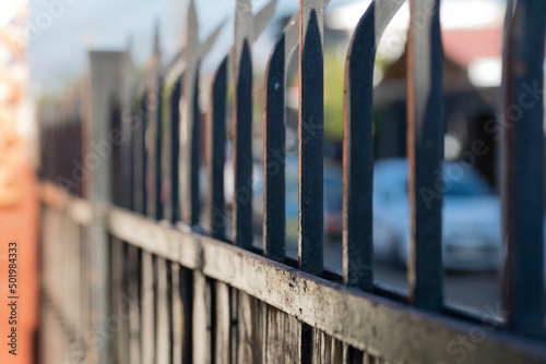 iron spikes of a security fence. gate of a house with its iron spikes to prevent theft photo