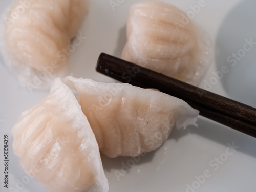 Dim Sum or Har Gow Shrimp Dumpling with Chopsticks, also anglizised as ha gow, haukau or hakao photo