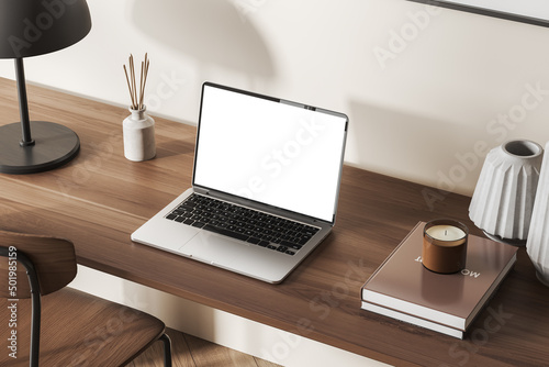 Workplace interior with laptop mockup screen on wooden desk, top view