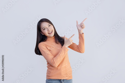 Asian Woman Pointing to Blank Space © charnsitr