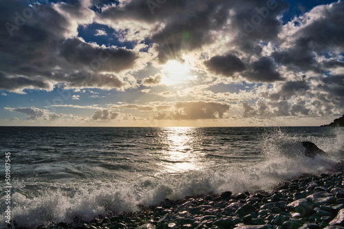 waves and wind by sunset on the coast on the Island of Madeira in the Atlantic Ocean of Portugal. Madeira