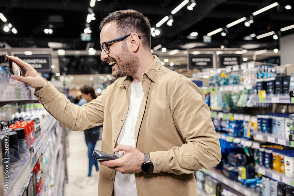A man choosing deodorant at supermarket. A man choosing deodorant at supermarket.