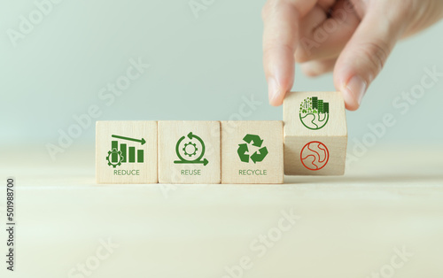 Reused, reduce and recycle concept. Limit global warming and climate change. Nurturing environmental awareness. Flipping wooden cubes from global warming to enviromental responsibility and protection. photo