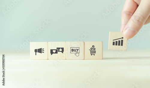 Growth of sales, marketing strategies concept. Data analytics for achieving business growth target. Increase sales in online store, e-commerce. Holding wooden cubes with sales growth. Postive progress photo
