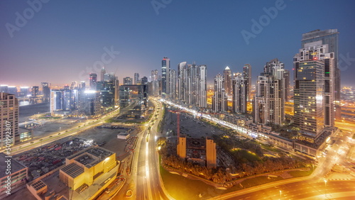 Bay Avenue with modern towers residential development in Business Bay aerial panoramic night to day timelapse, Dubai