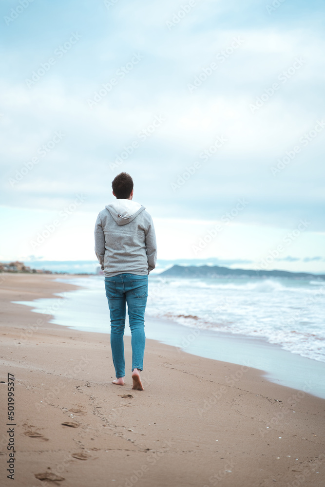 Lonely man walking on a foggy beach. depression concept.