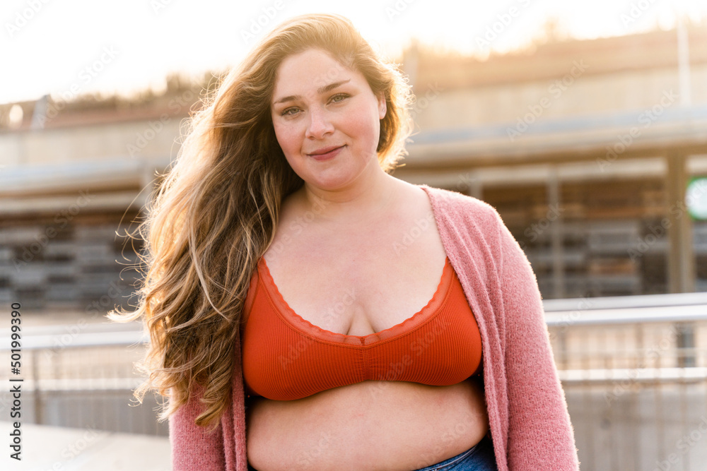 Beautiful plus size young woman outdoors, concepts about body acceptance, body positive and self esteem