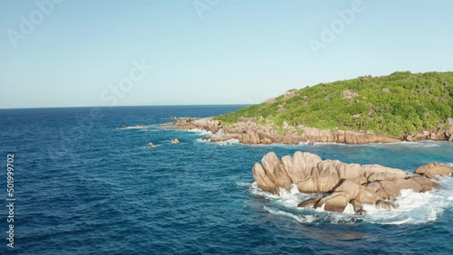 Aerial slider over granite sculptures Grand l'Anse rising from water