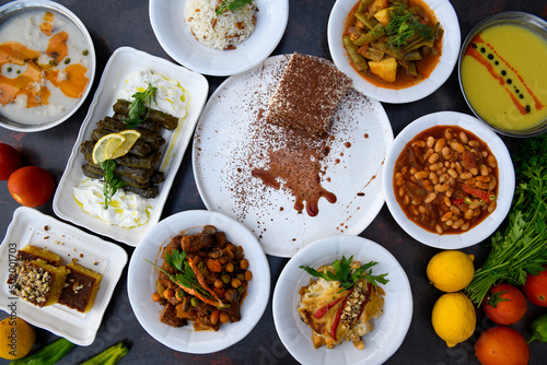 Table scene of assorted take out or delivery foods. Traditional Turkish cuisine. Various Turkish desert and cake. Top down view on a table. © enderbayindir
