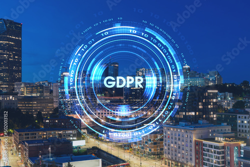 Illuminated aerial cityscape of Seattle, downtown at night time, Washington, USA. GDPR hologram, concept of data protection regulation and privacy for all individuals